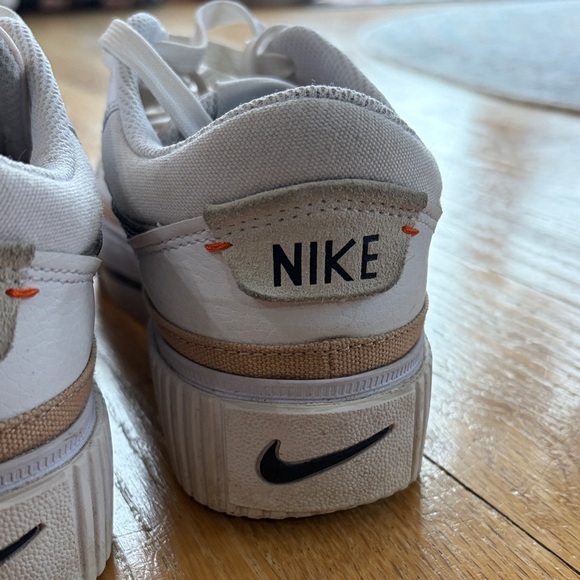 Nike White Low-Top Sneakers with Black Swoosh and Gold Accent - Picture 15 of 15